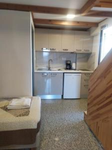 a small kitchen with white cabinets and a sink at Nicolas Apartments in Ierapetra