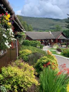 a garden in front of a house with flowers at Roam West in Fort William