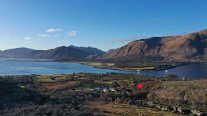 arial view of a lake with mountains in the background at Roam West in Fort William