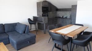 a living room with a couch and a table with chairs at Apartment in Crikvenica with sea view, balcony, air conditioning, WiFi 4973-1 in Crikvenica