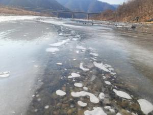 a body of water with snow on the ice at Tomato Pension in Hongcheon