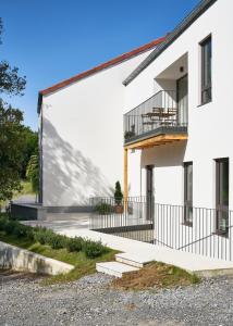 a white building with a balcony on the side of it at BAO 4 / APARTAMENTO CON TERRAZA in Somo +3 photos