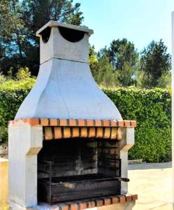 a brick oven with a roof on top of it at Villa Can Mestreso Suite Ibiza in Sant Joan de Labritja