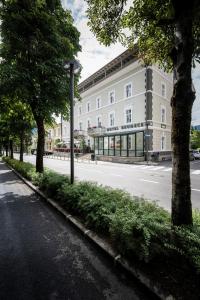 an empty street in front of a building at Hotel Bruneck Design-Apartments in Brunico