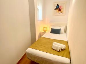 een kleine slaapkamer met een bed met een handdoek erop bij Apartamento acogedor en el centro de Cambrils in Cambrils