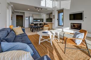a living room with a blue couch and a table at Villa AmberBlue Pefkos in Pefki Rhodes
