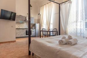 a bedroom with a bed with towels on it at Casa Vacanze Naxos in Lido di Ostia