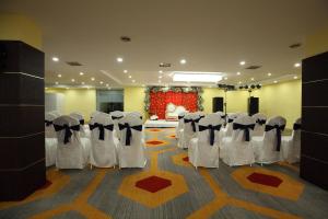 um quarto com um monte de cadeiras e uma mesa em Click Hotel Transport Nagar em Lucknow