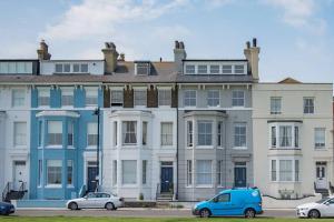 a large house with cars parked in front of it at The Lookout - Stunning sea view apartment in Deal