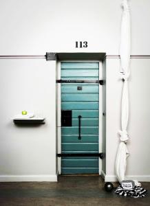 a blue garage door with a sign on it at Långholmen Hotell in Stockholm