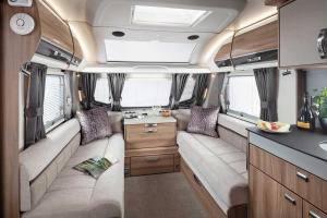 an interior view of an rv with two seats and a kitchen at Pinetum Gardens Retreats in St Austell