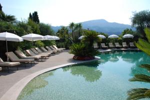 a pool with lounge chairs and umbrellas at a resort at Domaine De Respelido in Carros
