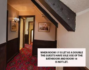 a hallway of a hotel with a sign on the wall at Stow Lodge Hotel in Stow on the Wold