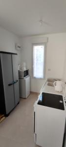 a white kitchen with a sink and a refrigerator at Noyers Val de Cher in Noyers-sur-Cher +7 photos