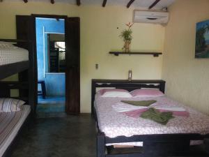 a bedroom with a bed with pink pillows on it at Casa Nova in Puerto Colombia