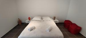 a bedroom with a large white bed with two pillows at Noyers Val de Cher in Noyers-sur-Cher