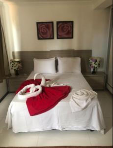 Cama o camas de una habitación en Mandakaru Residence Flats da Jô