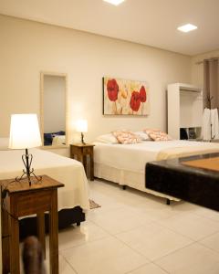 Säng eller sängar i ett rum på Flats Premium Jabaquara