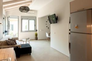 a kitchen and living room with a refrigerator at Garden House Preveza in Preveza