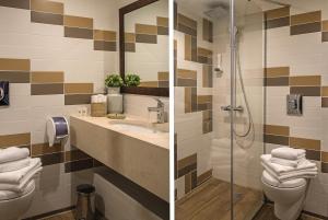 a bathroom with a toilet and a sink and a shower at The Stay by Aston Hotel Central Square - Free Compliments - Free Wi-Fi - TOP LOCATION - Nearby Paid Parking in Plovdiv +23 photos