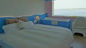 a bedroom with a large bed and a bath tub at 南灣飯店 Kenting Nanwan Hotel in Nanwan