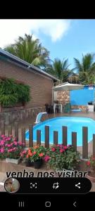 a picture of a swimming pool in a house at Chalé do Tio Beto - Caraguatatuba in Caraguatatuba