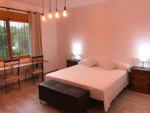 a bedroom with a bed and a table and chairs at El cortijo de la abuela in Benahadux