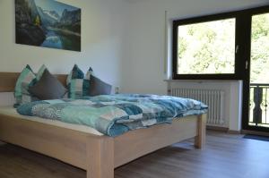 מיטה או מיטות בחדר ב-Ferienhaus Tüchersfeld