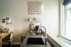 a kitchen with a sink and a window at B&B Amsterdam Amstel Apartment in Amsterdam