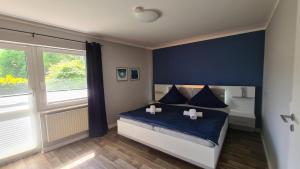 a bedroom with a bed with blue sheets and a window at 03 Blumenwiese in Parchtitz