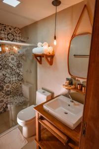 uma casa de banho com um lavatório, um WC e um chuveiro em EcoCharme Pousada Netuno em Fernando de Noronha