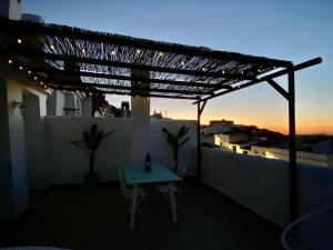 a table on a balcony with a sunset in the background at Mirador Deluxe in Segura de León