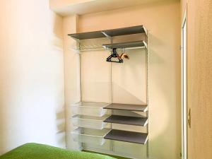 a walk in closet with a glass shelving unit at Ferienwohnung Fuchsbau in Brombachtal