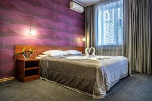 Säng eller sängar i ett rum på Hotel Zagreb