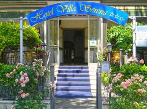 a blue sign for a building with stairs and flowers at Hotel Villa Serena in Castrocaro Terme