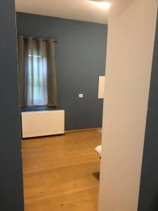 an empty room with a window and a wooden floor at Latour Mestia in Mestia