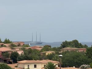 a view of a town with a boat in the water at Acqualife 4 luxury home in Arzachena