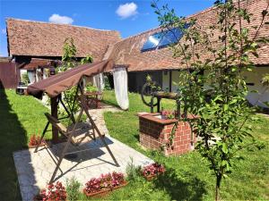 a gazebo in the yard of a house at Casa Marta in Bărcuţ