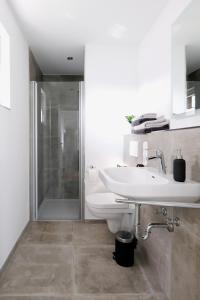 a bathroom with a toilet and a sink and a shower at lütte Heidepension in Schneverdingen