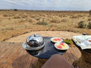 a grill with two plates of fruit on a table at Amanya 1 -Bed King Lion Tent in Amboseli +34 photos