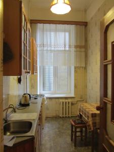 cocina con fregadero y ventana en Old Flat Apartments on Belinskogo, en San Petersburgo