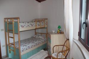 a bedroom with two bunk beds and a chair at Ville Alba & Azzurra in Polignano a Mare