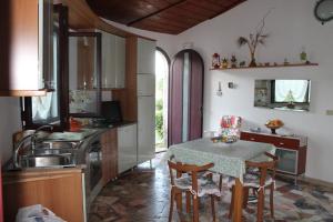 a kitchen with a table and chairs and a sink at Ville Alba & Azzurra in Polignano a Mare +37 photos