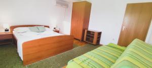 Postel nebo postele na pokoji v ubytování Apartments Villa Anna + 37 fotografií