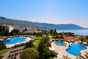 a beach with palm trees and palm trees at Iberostar Bellevue - All Inclusive in Budva