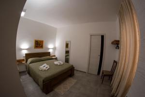 Łóżko lub łóżka w pokoju w obiekcie La terra del benessere