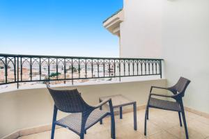 two chairs and a table on a balcony at Iberostar Selection Royal El Mansour in Mahdia