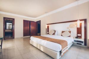 a large bedroom with a large bed and a table at Iberostar Selection Royal El Mansour in Mahdia