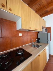 a kitchen with a sink and a stove at Apartamento Elena 11 in Lajares