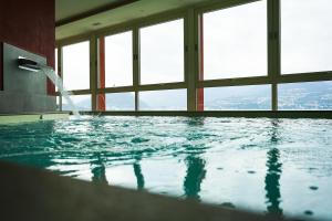 a large swimming pool with windows in a building at Il Porticciolo in Laveno-Mombello